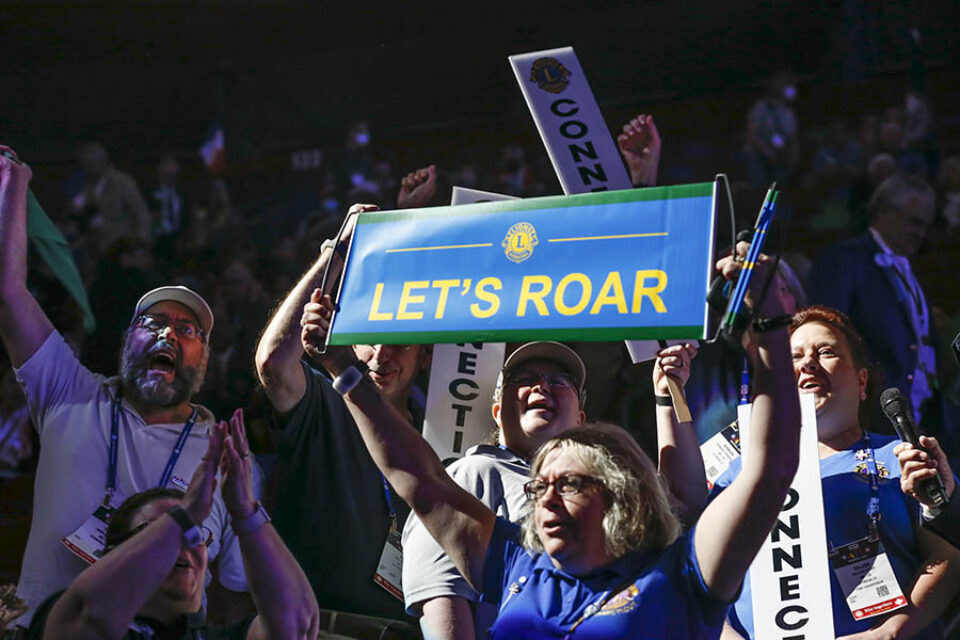 Montreal convention delegates wave placards with slogans
