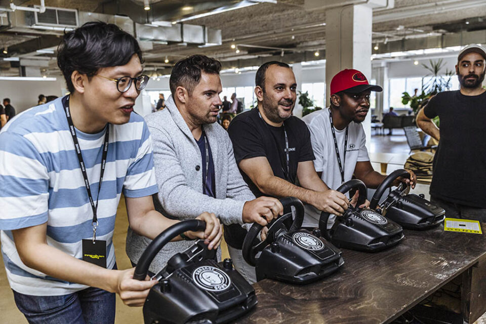 Event delegates playing Mario Kart, Montreal tech event photography
