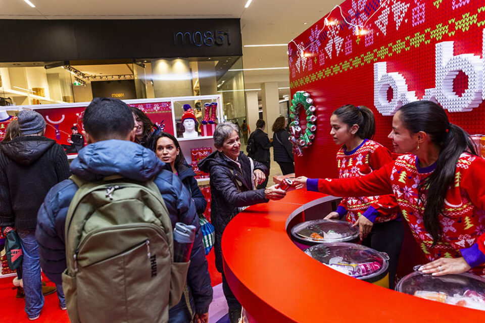 Woman receiving can of Merry Berry Bubly sparkling water at a Montreal corporate event