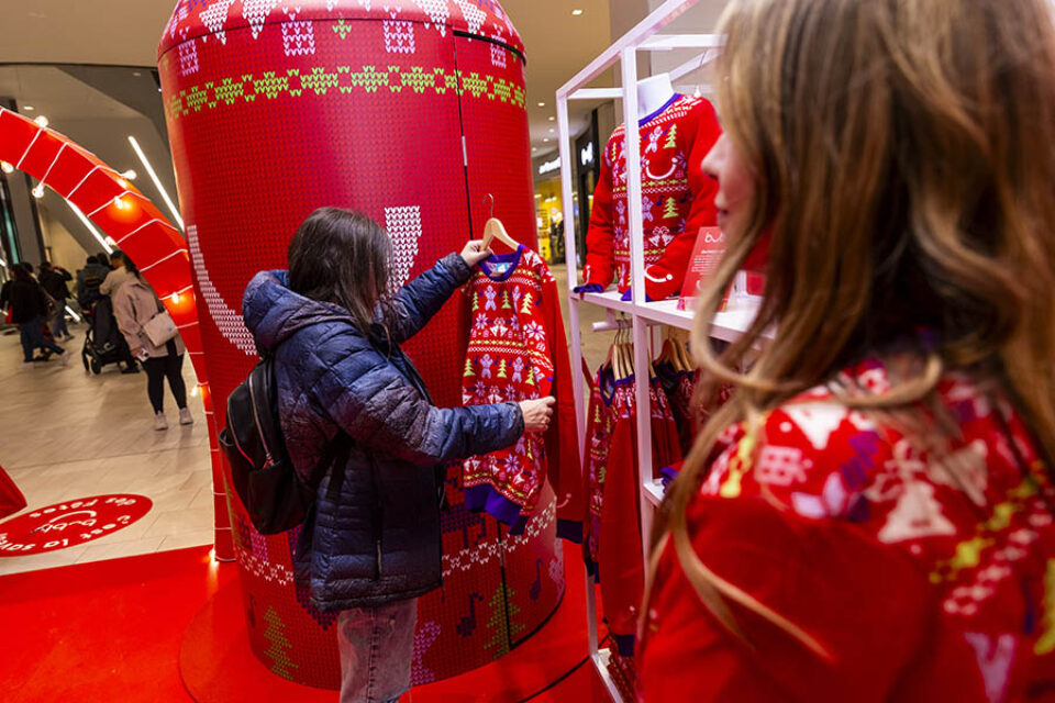 Woman looking at Christmas sweater at corporate event in Montreal