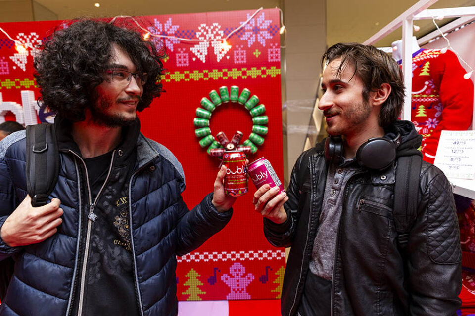 Event attendees with cans of Merry Berry Buble at a Bubly event - Montreal event photography