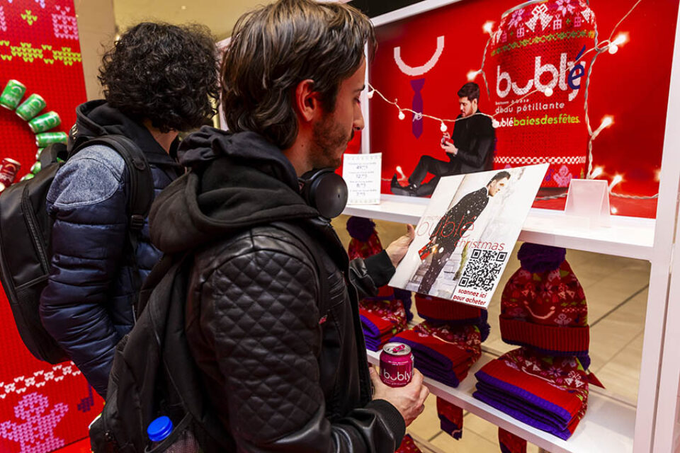 Man looking at Michael Buble Christmas album at a Montreal event