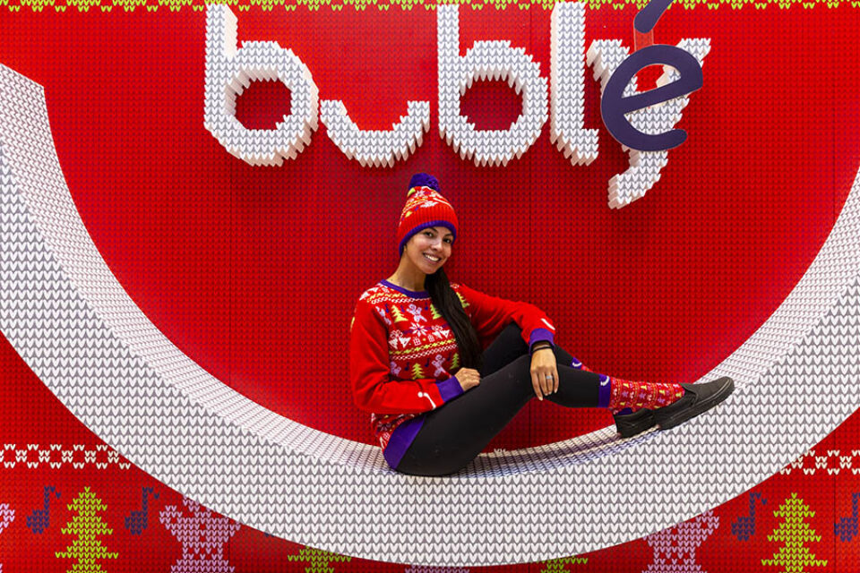 Montreal event photographer shot of woman modelling Christmas wear at Buble stand