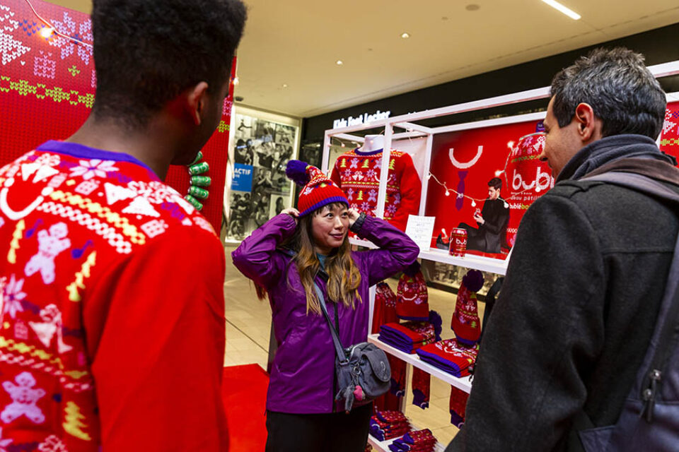 Woman trying on Christmas hat at Montreal corporate event