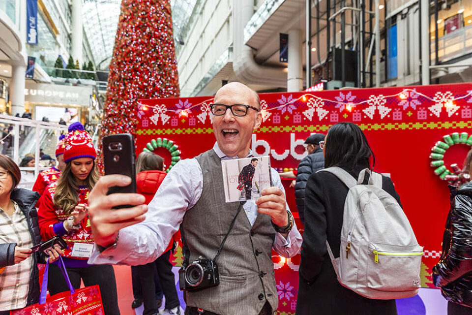 Toronto event photographer image of Michael Bublé fan takes photo with album