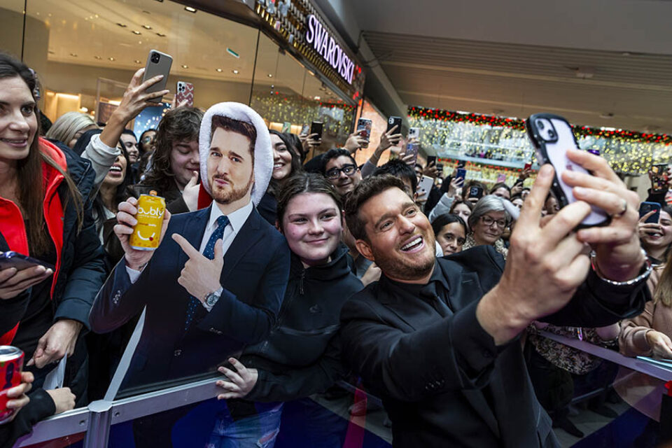 Michael Bublé taking a pitcure with a fan at his event in Toronto