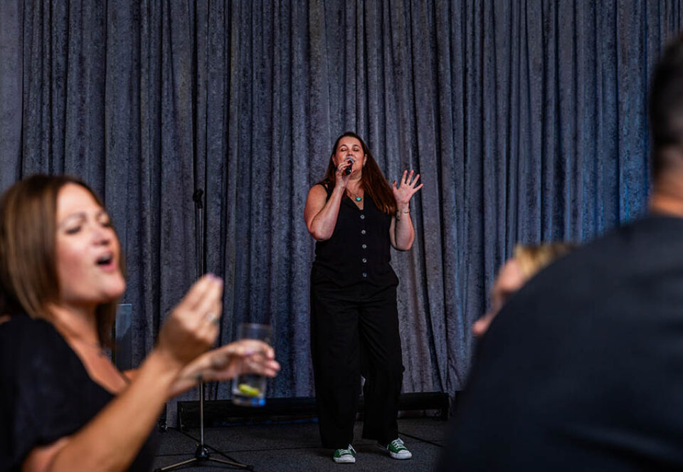 Women singing karaoke at a Montreal corporate event