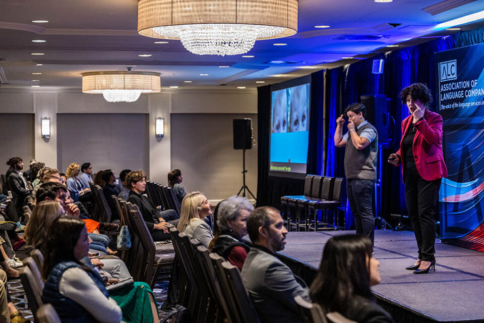 Presenter onstage at a corporate event in Montreal