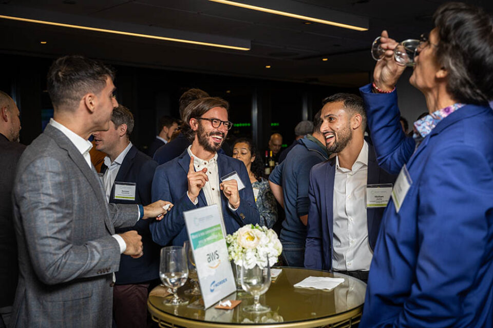 Event guests share a joke at a networking event in Montreal