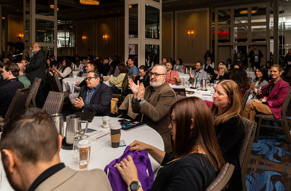 Montreal conference audience applaud a speaker