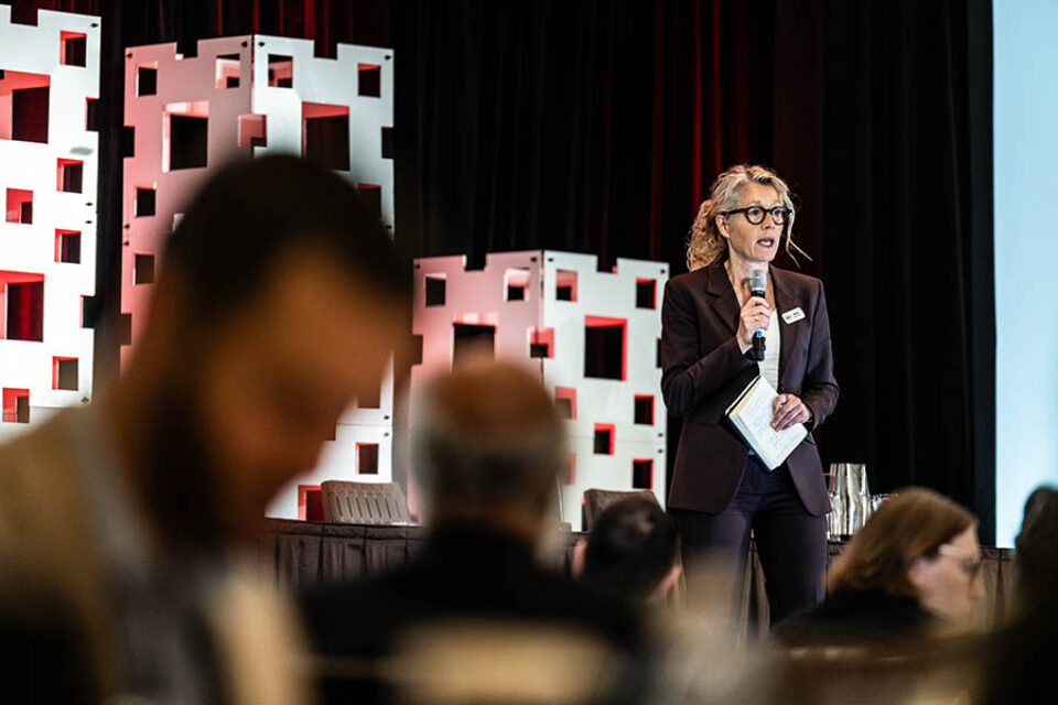Event speaker onstage at a conference in Montreal