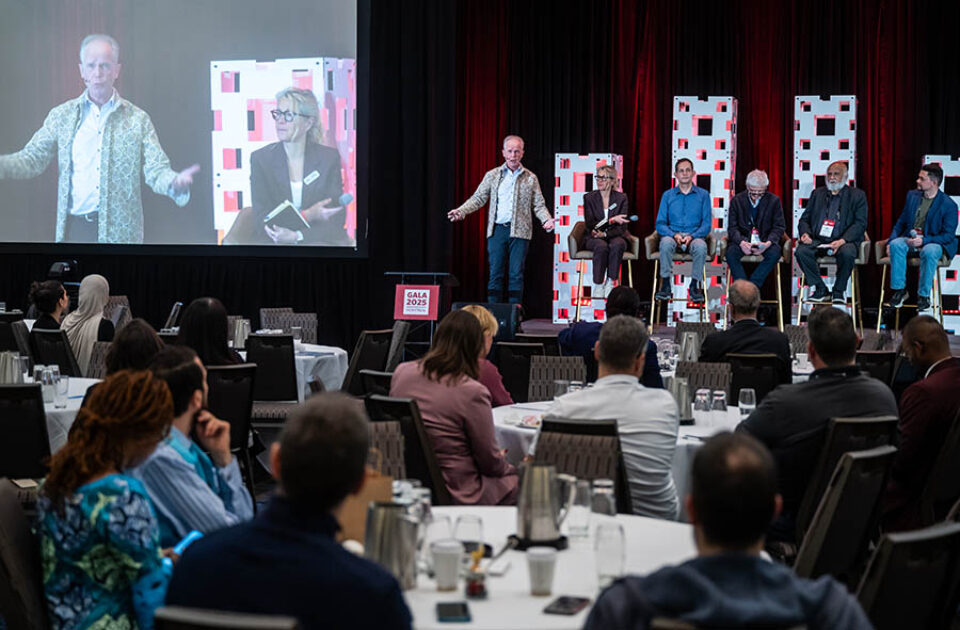 Presenter leading a panel discussion during a conference in Montreal