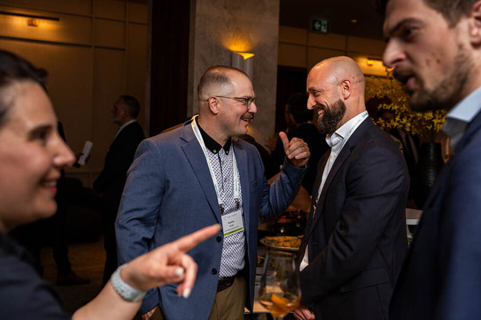 Montreal business event photography guests share a joke