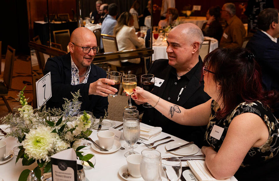 Montreal business celebration photographer shot of guests toasting