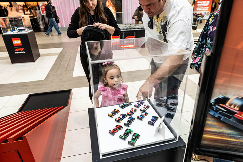 Montreal F1 event photographer - girl looks at LEGO racing cars