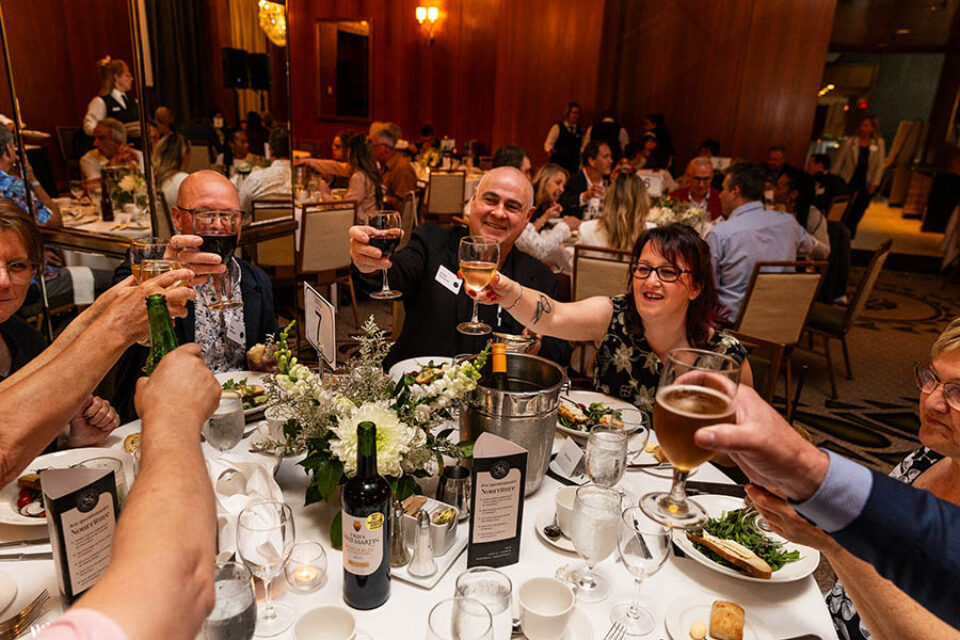 Montreal business celebration event guests toast one another