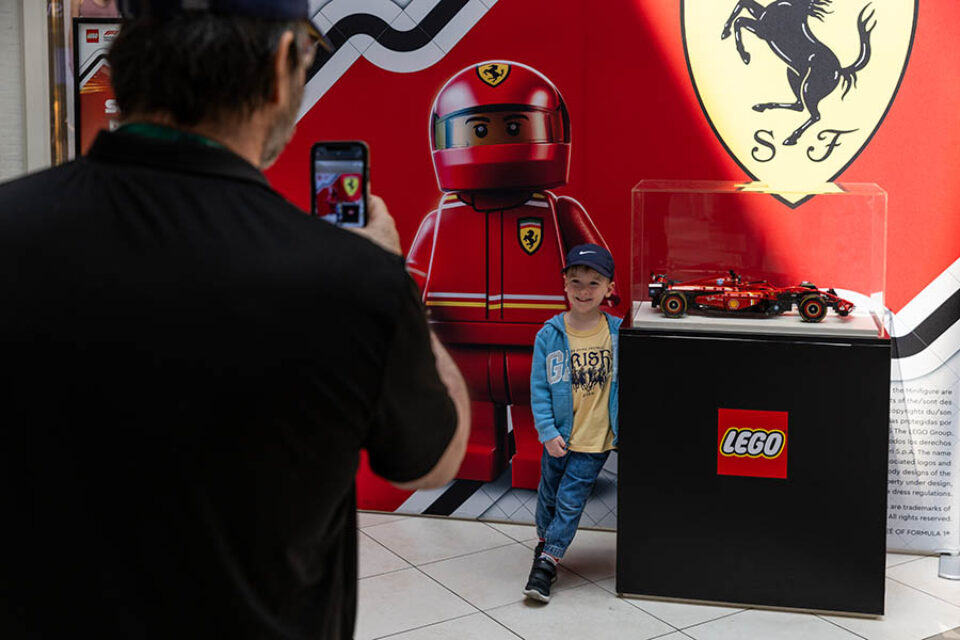 Boy poses wth LEGO Ferrari F1 car at Montreal event