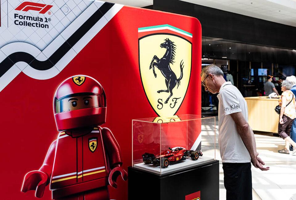 Montreal F1 event photographer shot of a visitor admiring LEGO Ferrari F1 racing car
