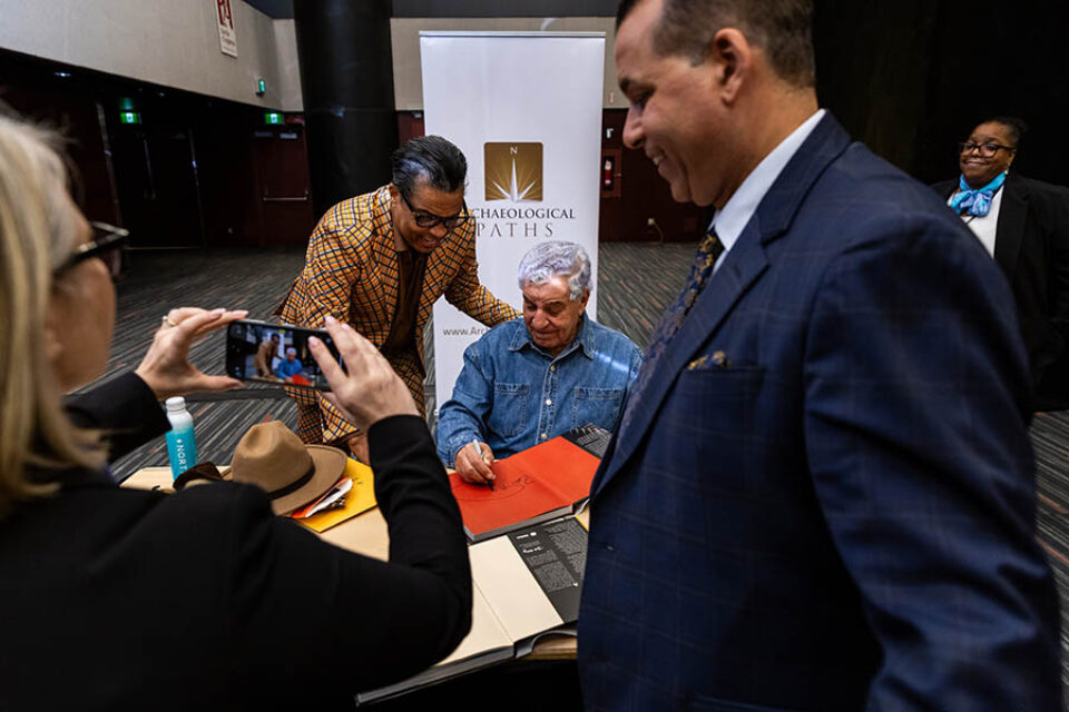 Montreal celebrity event photography, Dr Zahi Hawass sings a fan's book