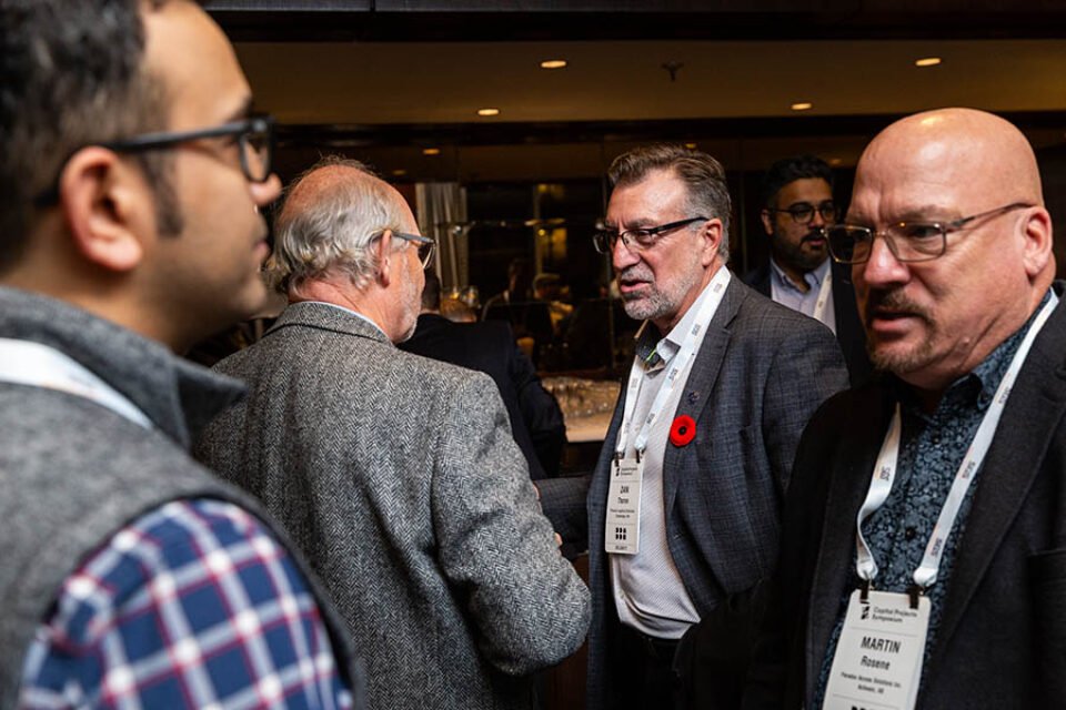 Men chat at business reception, Montreal conference photographer
