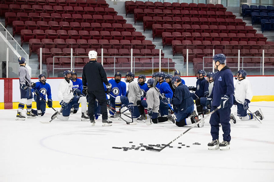 Coaching during college hockey practice, image by Montreal college sports photographer