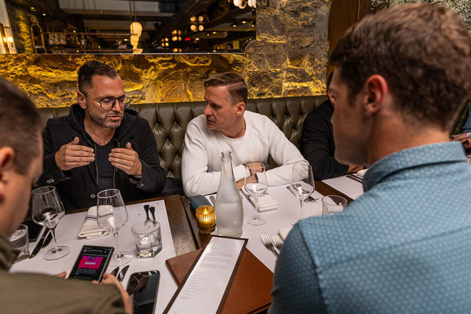 Guests chat during a business dinner in Montreal's Old Port