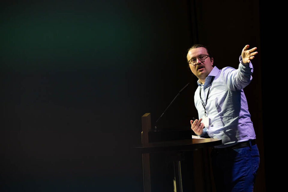 Onstage presenter gesticulating, Montreal summit photography