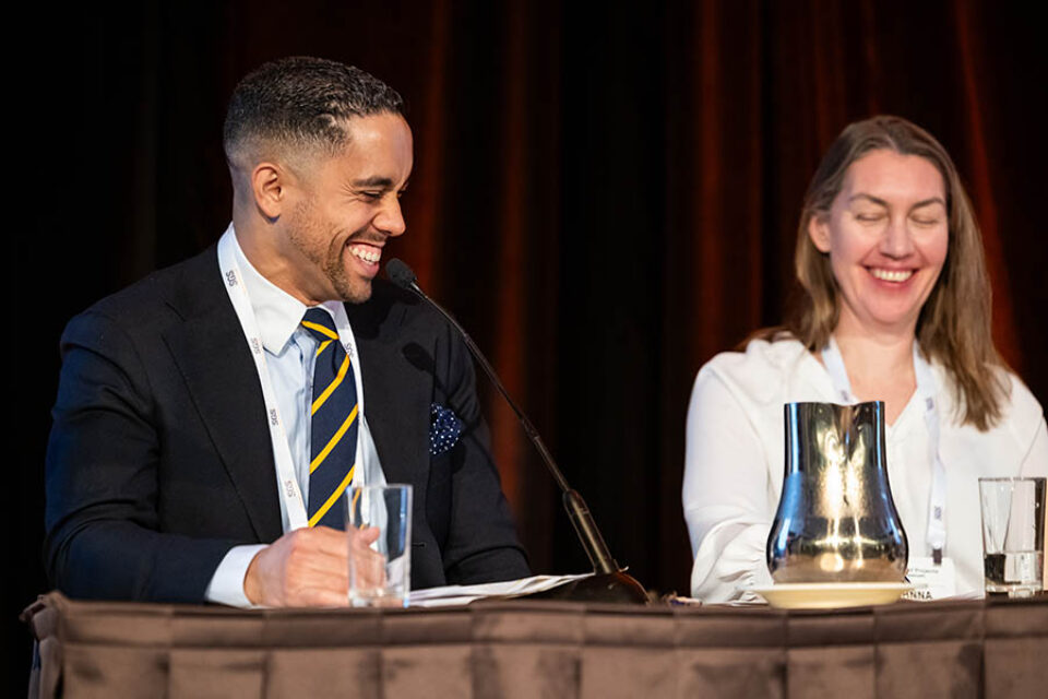 Event panelists share a joke, Montreal conference photography