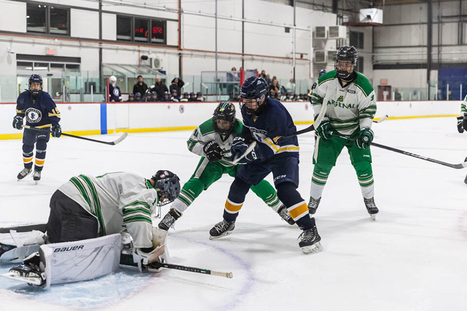 Hockey game, goalmouth action, image by Montreal college sports photographer