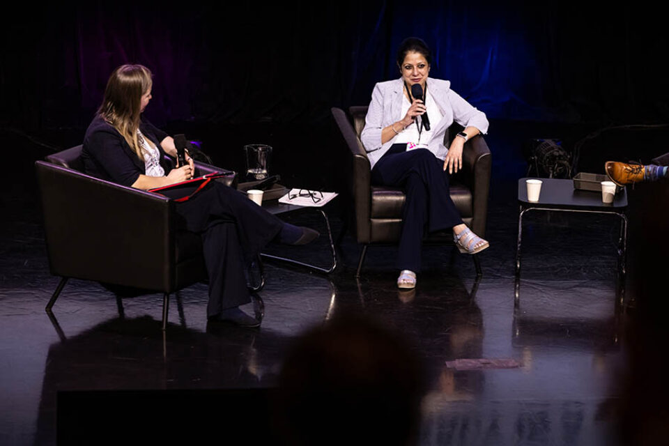 Woman talking on panel, Montreal summit photography