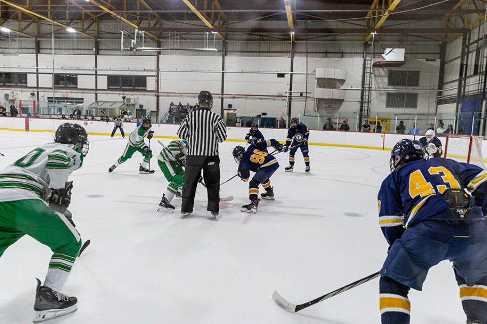 Hockey game face-off shot by Montreal college sports photographer