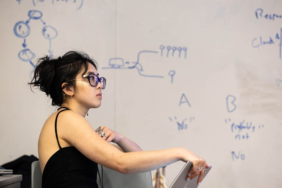 Young woman listening to speaker during a corporate event