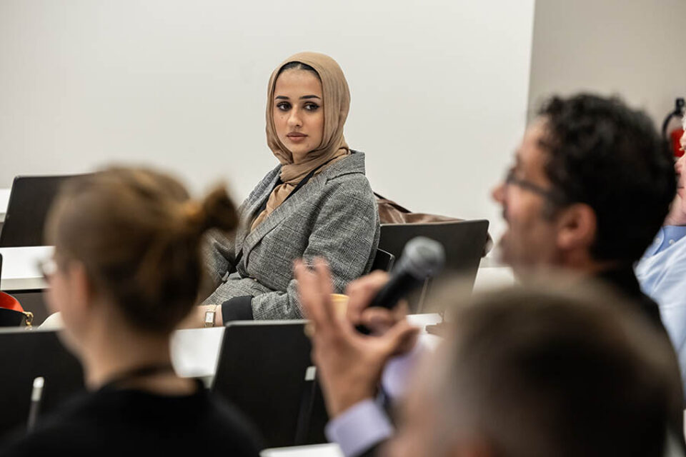 Woman listening to speaker at Montreal summit