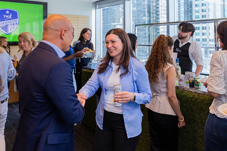 Networking event guests greet one another